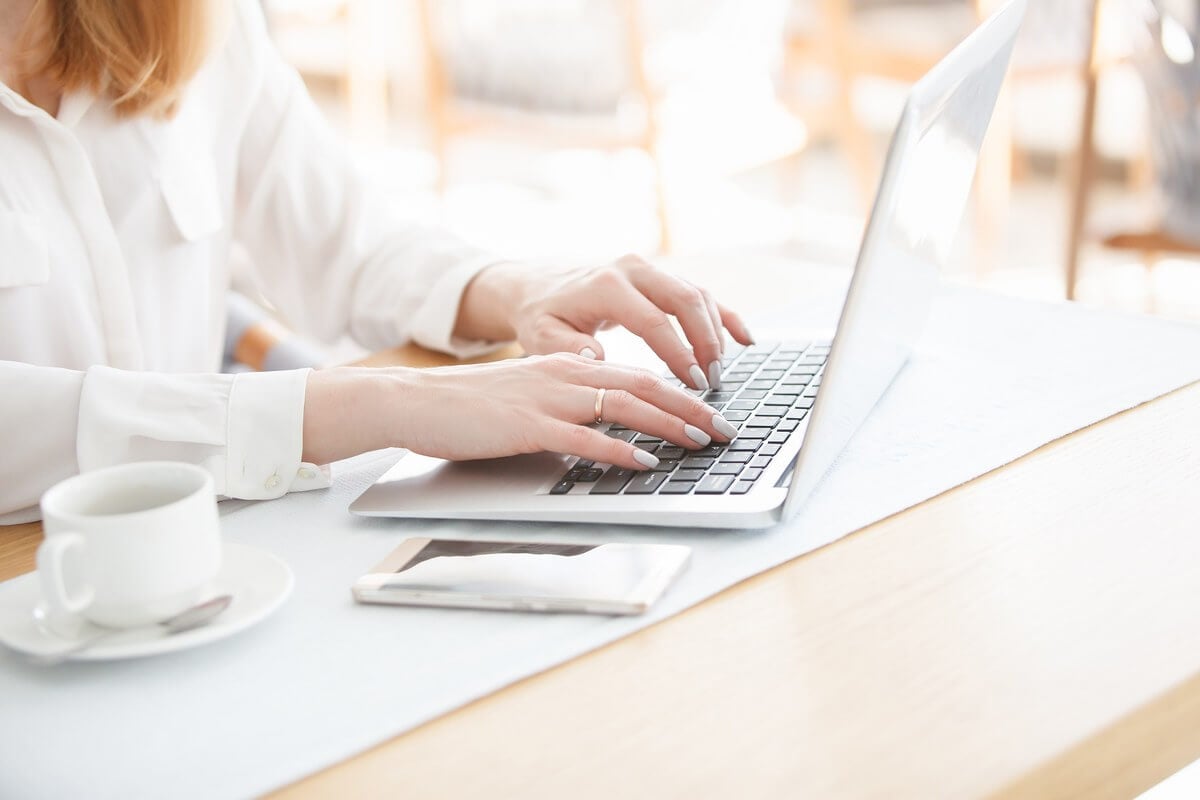hands-typing-on-a-laptop-in-a-bright-workspace-1