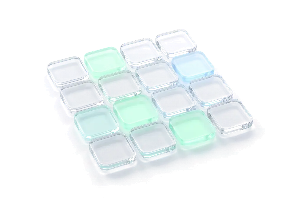 Grid of glass tiles, some glowing mint and blue